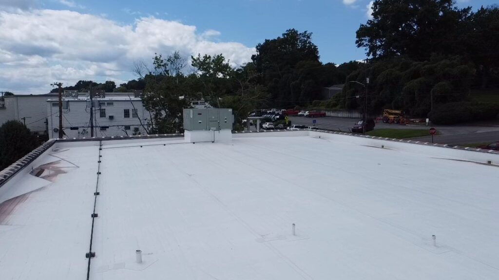 Flat commercial roof being repaired in Asheville NC