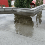 ponding on a flat commercial roof, commercial flat roof drainage, flat roof repair Asheville, commercial roofing Asheville NC, stop roof ponding, commercial roof drainage solutions, flat roof water pooling, flat roof commercial repair, commercial roof leaks, flat roof replacement Asheville, TPO commercial roofing, EPDM roof ponding fix, prevent commercial roof damage, roof maintenance Asheville business, commercial roof inspection service